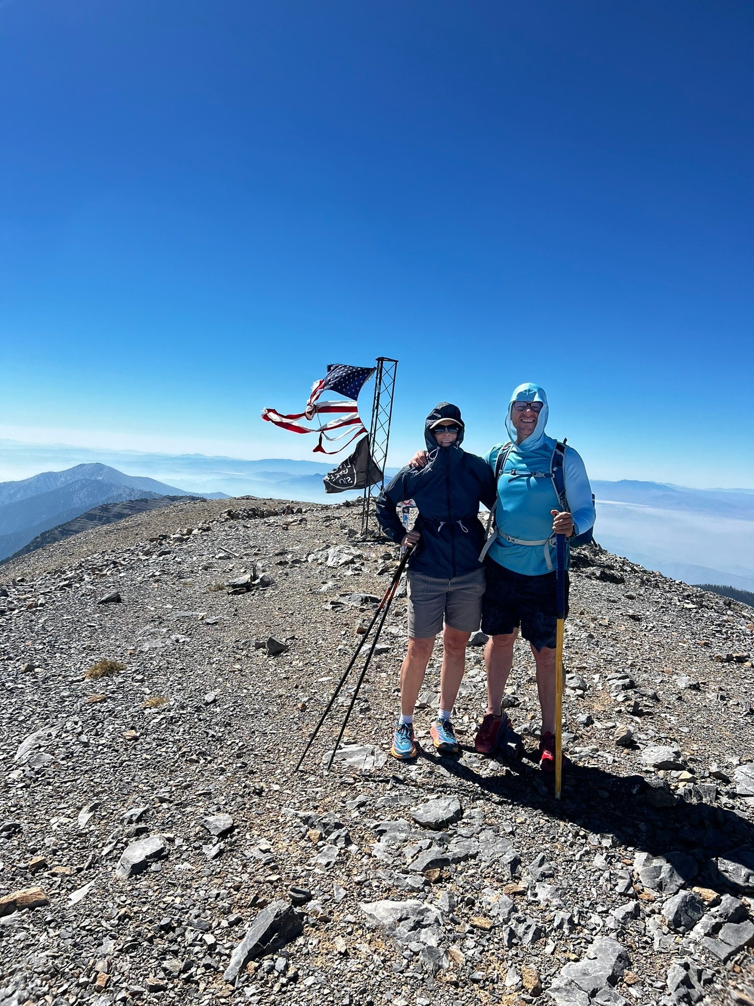 EPIC90 member standing on a mountain summit